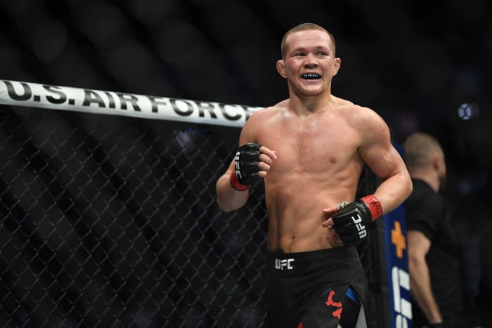 Petr Yan (red gloves) reacts after defeating Urijah Faber (not pictured) during UFC 245 at T-Mobile Arena.
